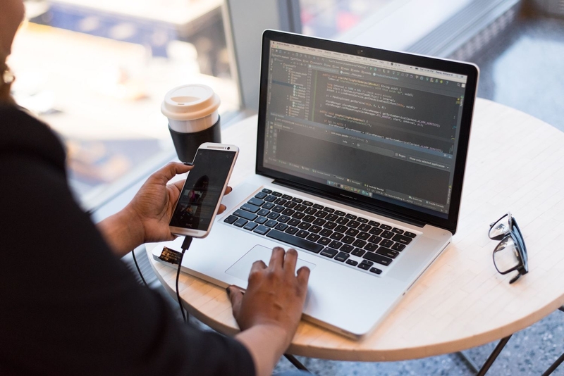 A programmer testing an app on their phone.