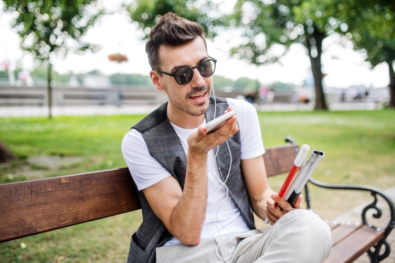 A blind man using speech recognition to navigate through his phone